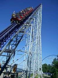 Roller coaster train ascending a steel structure