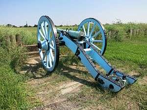 Photo shows a French 4-pounder cannon mounted on a light blue and black carriage.