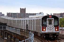 A number 6 train, consisting of R142A train cars, approaching the Parkchester station