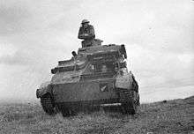 Tank facing the camera, with a soldier on top