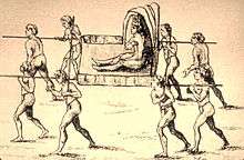 An antique line drawing of a man with a feather crown being carried by eight nearly naked carriers