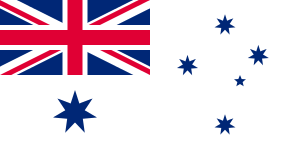 A white flag with the British Union Jack in the upper left canton. Five blue stars are positioned on the left in the shape of the Southern Cross, while a large sixth star is under the Union Jack
