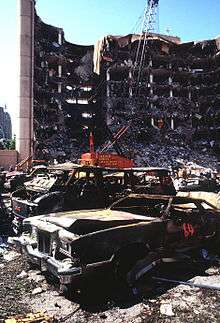 A view of the destroyed Alfred P. Murrah Federal Building, two days after the bombing, burned out automobiles in the foreground.