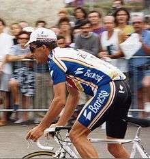 A man riding a bike in a cycling jersey.