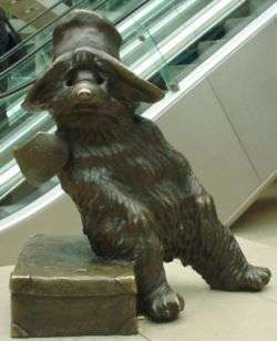 A statue of a bear with a hat.
