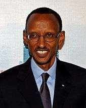 Close up photo of Paul Kagame smiling at the premiere of the film Earth Made of Glass