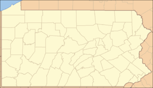A map of the state of Pennsylvania with a red dot in the northeast part