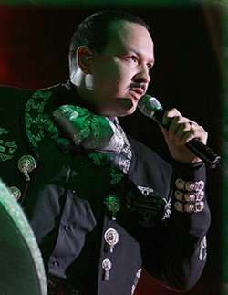 Pepe Aguilar singing onstage