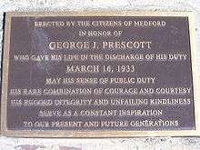 Black plaque with gold letters commemorating George J. Prescott