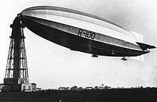 Airship with its nose secured to a high mast