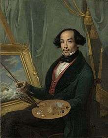 A Javanese man in a suit, holding a paintbrush