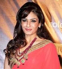 A picture of Raveena Tandon looking forward, smiling and posing for the camera