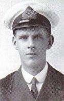 A head and shoulders portrait of a young man in naval military uniform. He is wearing a cap and has an oval shaped face.