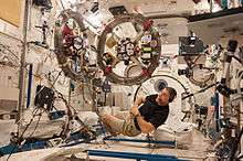 Two SPHERES satellites with the RINGS add-ons are being used in an experiment by NASA astronaut Michael Hopkins.