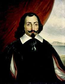 A half-length portrait of a man, set against a background that is a red curtain to the left and a landscape scene to the right. The man has medium-length dark hair, with a goatee and a wide mustache that is crooked up at the ends. He is wearing a white shirt with a wide collar, covered by a darker surcoat.