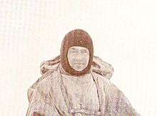 Man in winter coat wearing a balaclava or ski mask style headgear.