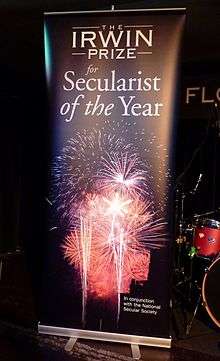 A roll-up banner reading "The Irwin Prize for Secularist of the Year"