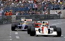 Senna's McLaren just ahead of Mansell's Williams on track