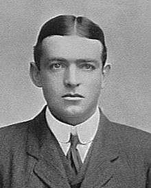 A young man wearing a tie, jacket and waistcoat.