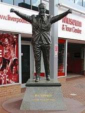 Statue of Bill Shankly with his arms held aloft