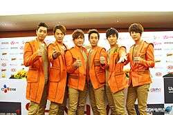 A photograph of Shinhwa at a press conference in 2012