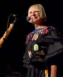 Sia singing to a microphone