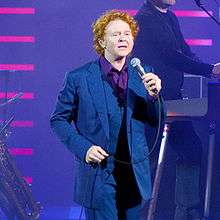 Colour photograph of Simply Red performing live onstage in 2009.