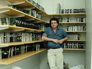 Picture of Simson Garfinkel surrounded by disk drives on shelves
