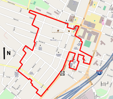 A street map showing the district boundary as a red line