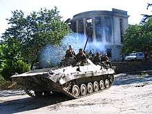 Tank-like vehicle with soldiers aboard