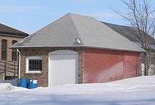 One-story brick garage with hip roof