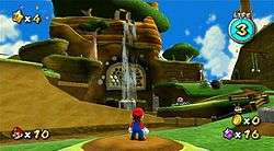 This screenshot shows Mario standing before a hillside lined with enemies and obstacles. The game's interface displays the number of Power Stars, life meter, number of coins and Star Bits, and number of lives