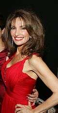 A woman with brunette hair, wearing red outfit.