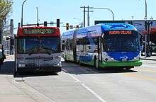 A Community Transit bus passing a parked Everett Transit bus