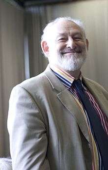 Smiling, bearded, white-haired man