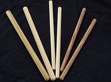 Different types of drum sticks for taiko, called bachi, are displayed flat on a surface.