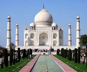 The Taj Mahal is a mosque-like structure of white marble with an onion-shaped dome, and a tall marble minaret at each corner