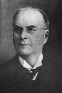 A black and white photographic portrait of Thayer Melvin in his later years.