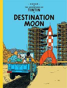 Calculus, Tintin, Snowy, and Haddock approach an enormous, under construction rocket ship in a jeep.