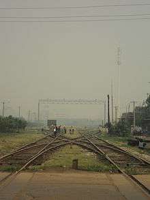 an X-shaped interception of railroads with a repair crew carrying out maintenance