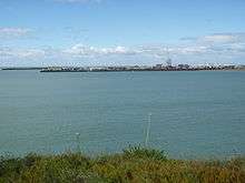 Photograph showing large breakwater construted at the mouth of Timaru Port.