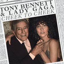 Tony Bennett and Lady Gaga holding hands and looking to the front