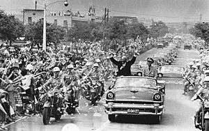While visiting Taipei, Taiwan in June 1960, U.S. President Dwight D. Eisenhower waves to crowds Taiwanese people from an open car next to Chiang Kai-shek.