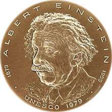 A gold, silver or bronze medallion featuring an image of Albert Einstein.