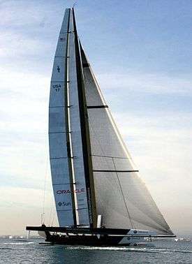 Color photograph of a racing catamaran underway with the starboard hull out of the water