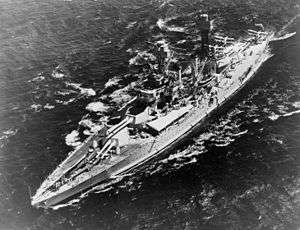 A large warship in the water, seen from above