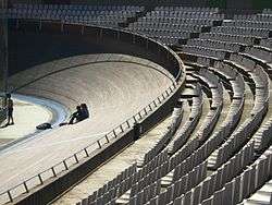 Wooden banked velodrome track with seating behind