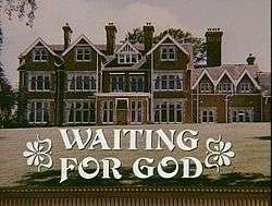 Front view of large English manor home with large lawn, with text "Waiting for God" superimposed