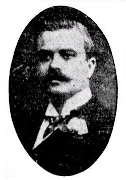 Man with moustache, wearing suit, in an oval frame