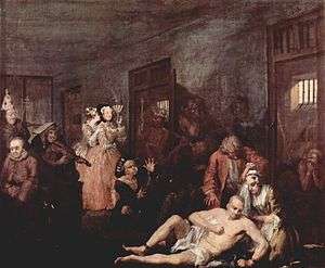 An 1735 oil version of the last scene from William Hogarth's A Rake's Progress, the story of a rich merchant's son, Tom Rakewell whose immoral living causes him to end up in Bethlem. A shaven-head and near-naked Rakewell is depicted in one of galleries of Bethlem. He sits on the floor while his right leg is being manacled by an attendant. A wigged doctor is standing over him.  Rakewell's spurned fiancé kneels beside him, crying. Inmates exhibiting various stereotypical forms of madness are shown in their open cells and in the corridor. Two fashionably dressed lady-visitors standing by the cell of a "urinating mad monarch", are clearly amused by the show. One holds a fan up to her face and is clearly smiling while her companion whispers in ear. Hogarth became a governor of Bethlem in 1752.